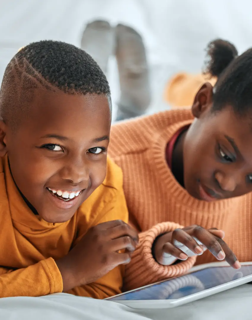 Children using a donated laptop in their classroom, illustrating how Tech On Hand's process delivers working technology to schools in Africa